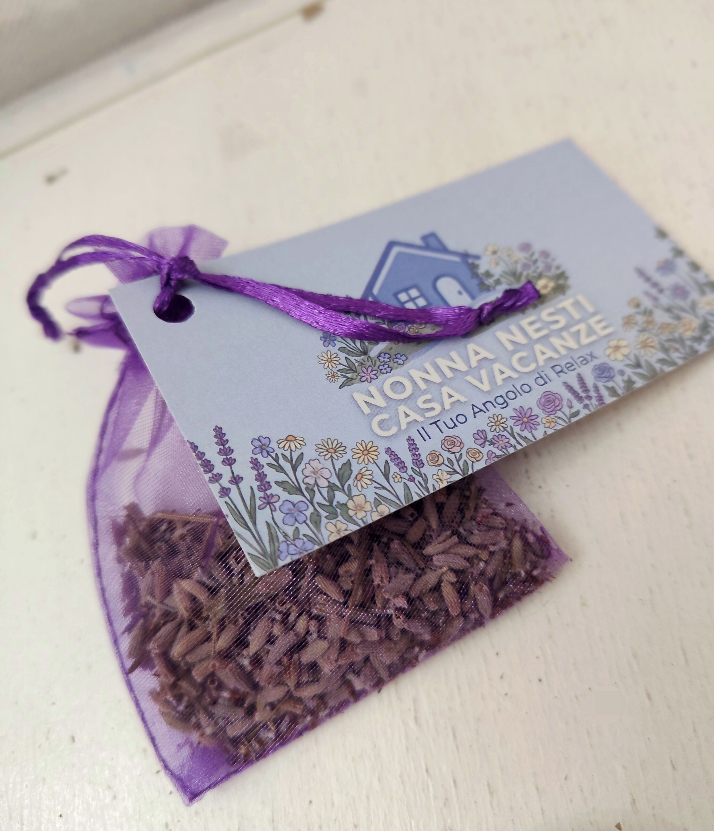 A purple drawstring bag with a tag, containing what appears to be dried herbs or spices.