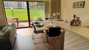 A modern dining area with a view of a grassy outdoor space. - Westhinder 200m From Sea (De Panne)