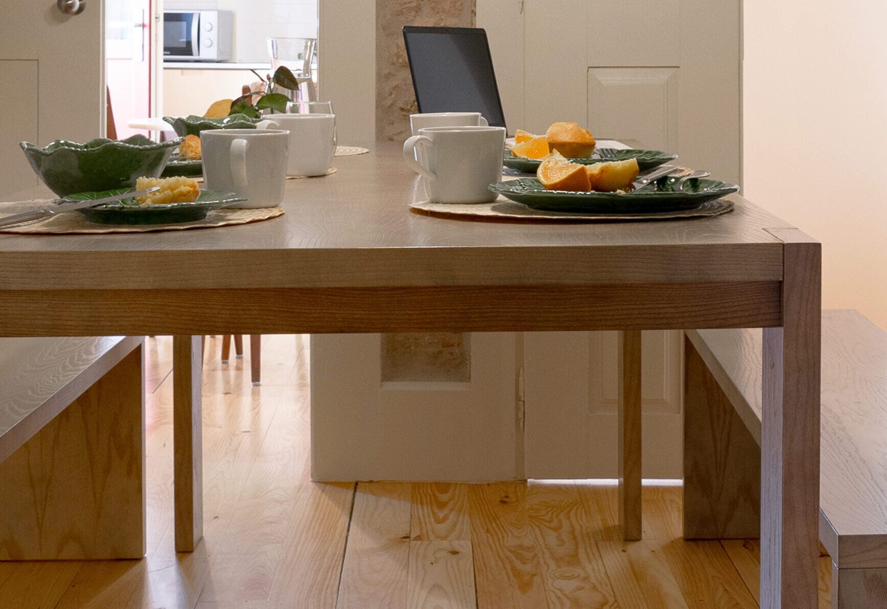 A dining table with plates, bowls, and cups.