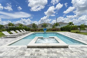 A swimming pool with lounge chairs, a hot tub, and a clear sky. - Last Minute Disney! Private Pool, Hot Tub, Game Room & Themed Bedrooms. Book Now! #65345 (Orlando)