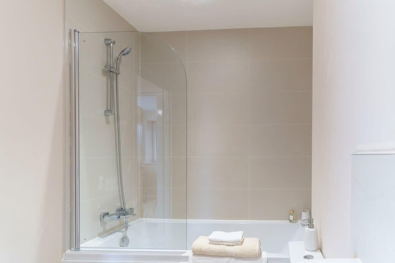 Bathtub, hair dryer, towels, shampoo