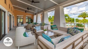 A covered outdoor living area with seating, a dining table, and a view of the outdoors. - Last Minute Disney! Private Pool, Hot Tub & Themed Bedrooms. Book Now! #66161 (Orlando)