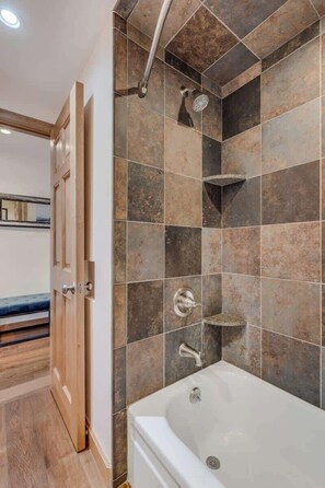 Bathtub, eco-friendly toiletries, hair dryer, towels
