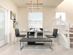 Enjoy meals with family and friends in this dining area, featuring a table for four and comfortable seating.