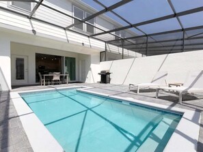 Relax by the pool surrounded by a spacious deck and lounge chairs.