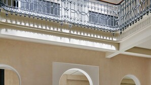 A spacious lobby with modern seating, a high ceiling, and a balcony. - Mercer Plaza Sevilla 5 GL (Seville)