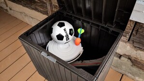 A trash bin with a soccer ball and a toy dart. - Creekside Cabin w Hot Tub, Fire Pit, Deck & Grill! (Mount Jackson)