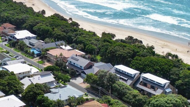 A coastal residential area with houses and a beach. - Welcome to "Buddha Beach House," the perfect beach retreat in coastal haven Sawtell. (Sawtell)