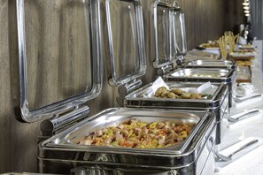 A buffet line with multiple stainless steel serving trays containing various dishes. - Seven Gardens Hotel (Riyadh)