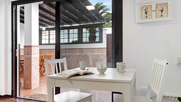 A dining area with a table, chairs, and a book.