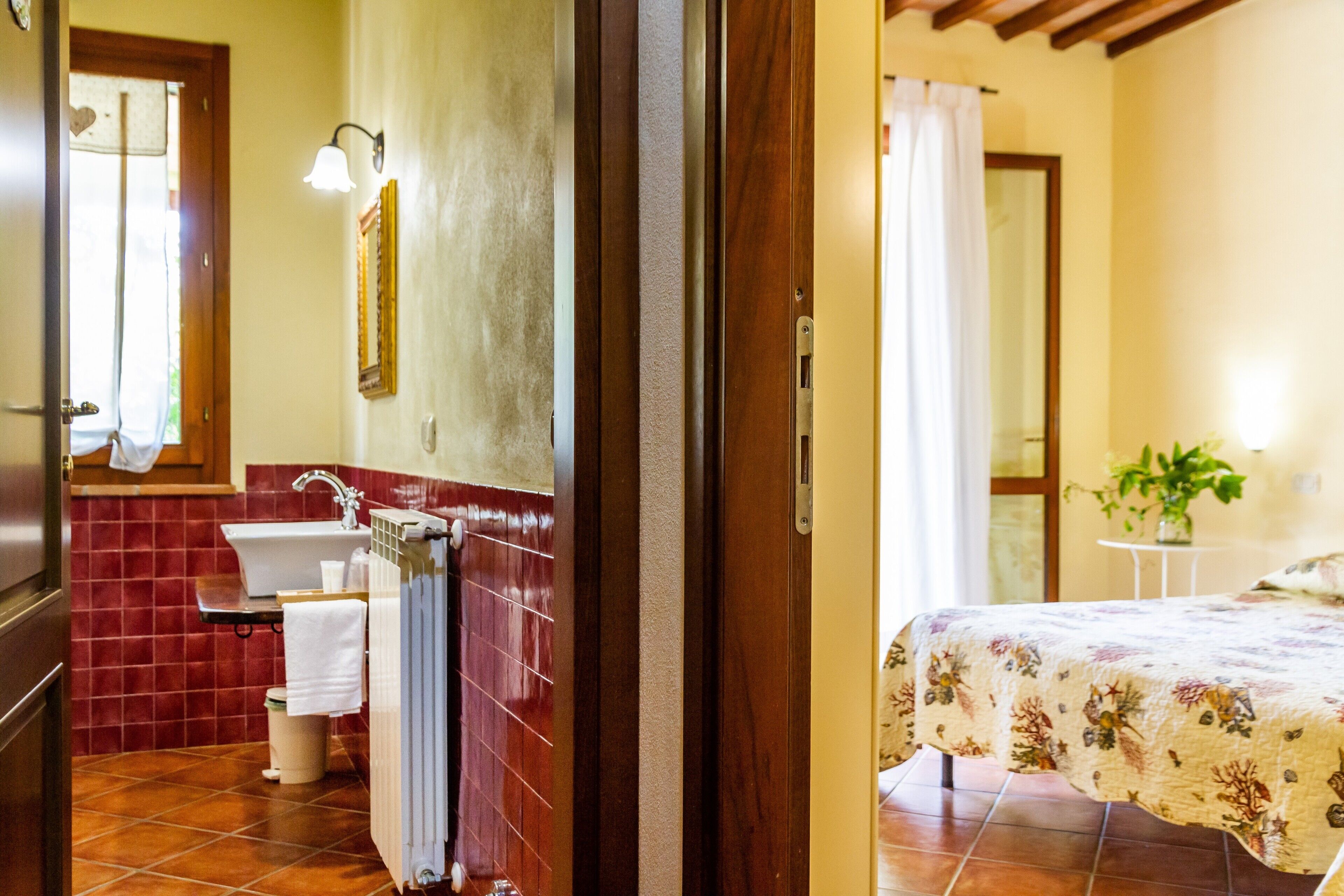 A bathroom with a sink, mirror, and towel rack.