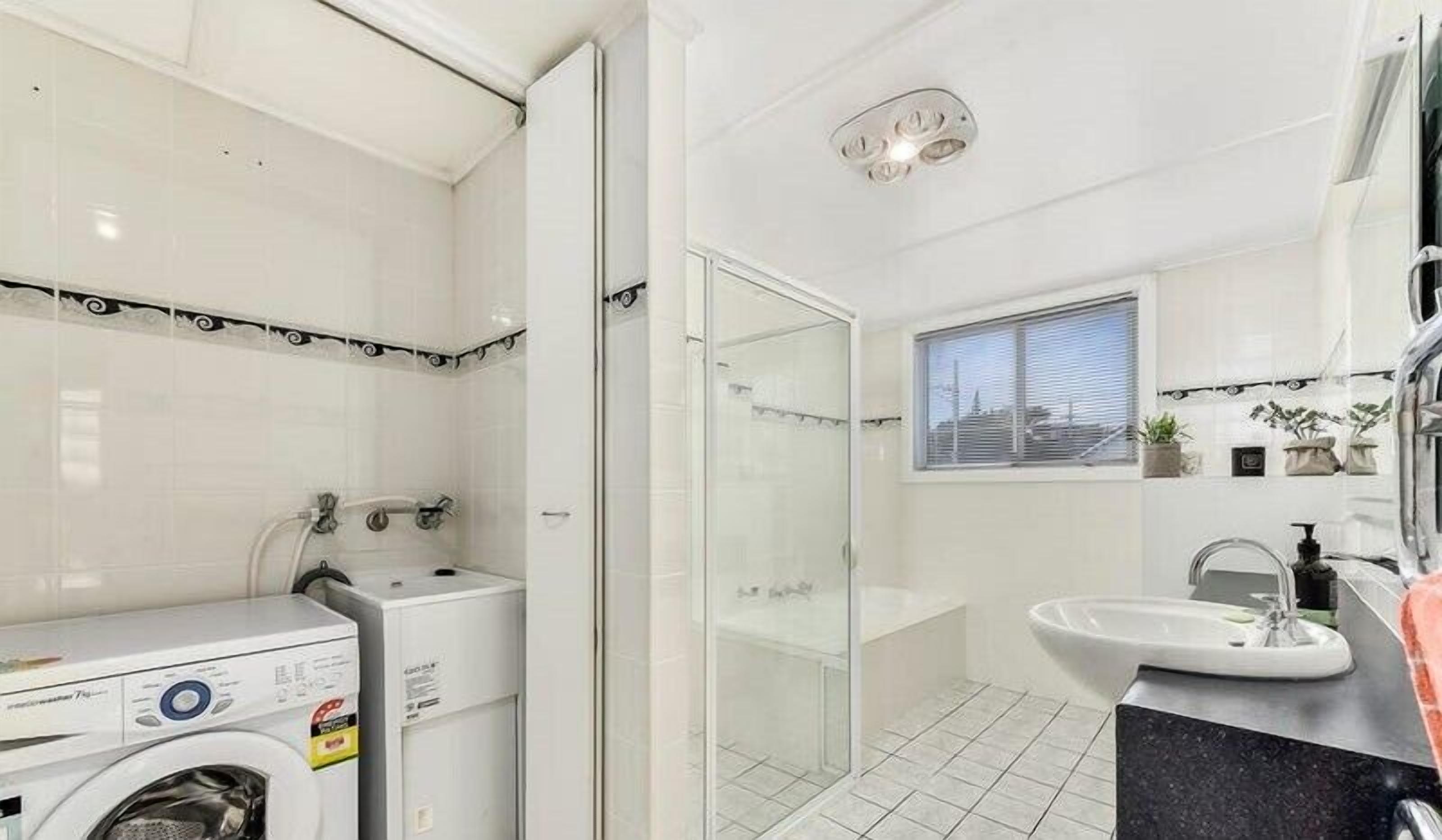 Bathtub, hair dryer, towels, toilet paper