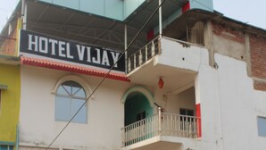 A multi-story building with a sign reading "HOTEL VIJAY". - Hotel Vijay (Rajgir)