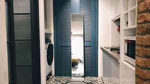 A narrow hallway with a tiled floor featuring a bear design, leading to a room with a bed and a window. - Sweetheart in Saigon - 5mins to the Notre Dame Saigon (Thành phố Hồ Chí Minh)