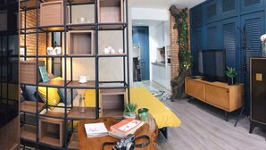 A modern living room with a brick accent wall, a yellow sofa, and a wooden coffee table. - Sweetheart in Saigon - 5mins to the Notre Dame Saigon (Thành phố Hồ Chí Minh)
