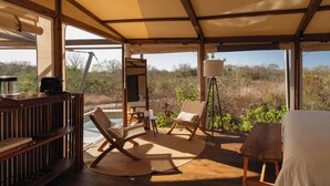 A covered outdoor seating area with wooden furniture, a table, and a view of the surrounding landscape. - Viatura Hacienda Xtojil, Yucatan, Merida, with Optional All Inclusive (Timucuy)