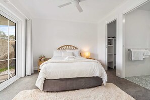A bedroom with a bed, bedside table, lamp, and a view through a window. - Peaceful & Cosy Studio - Immaculate Presentation (Orange)