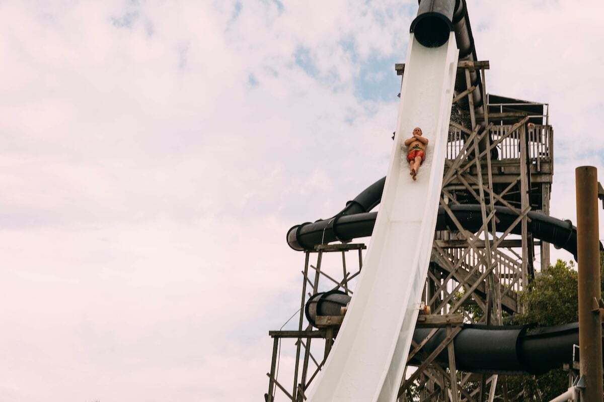 A water slide structure with a white surface and a metal framework.