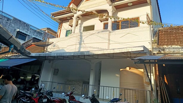 A two-story house with a balcony and a garage. - Kata S.T House 2 (Karon)