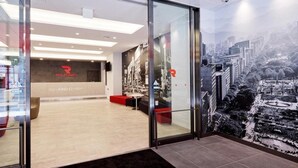 A modern interior with a reception desk labeled "Red Planet" and a cityscape mural on the wall. - Red Planet Sapporo Susukino Central (Sapporo)