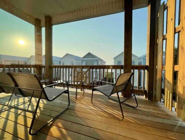 Enjoy unobstructed views of the surrounding landscape from this outdoor deck with comfortable seating.
