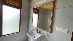 A bathroom with a white sink, a mirror, and a window. - Spacious Wooden Room w/ Attic Olive Manali Cottage (Manali)