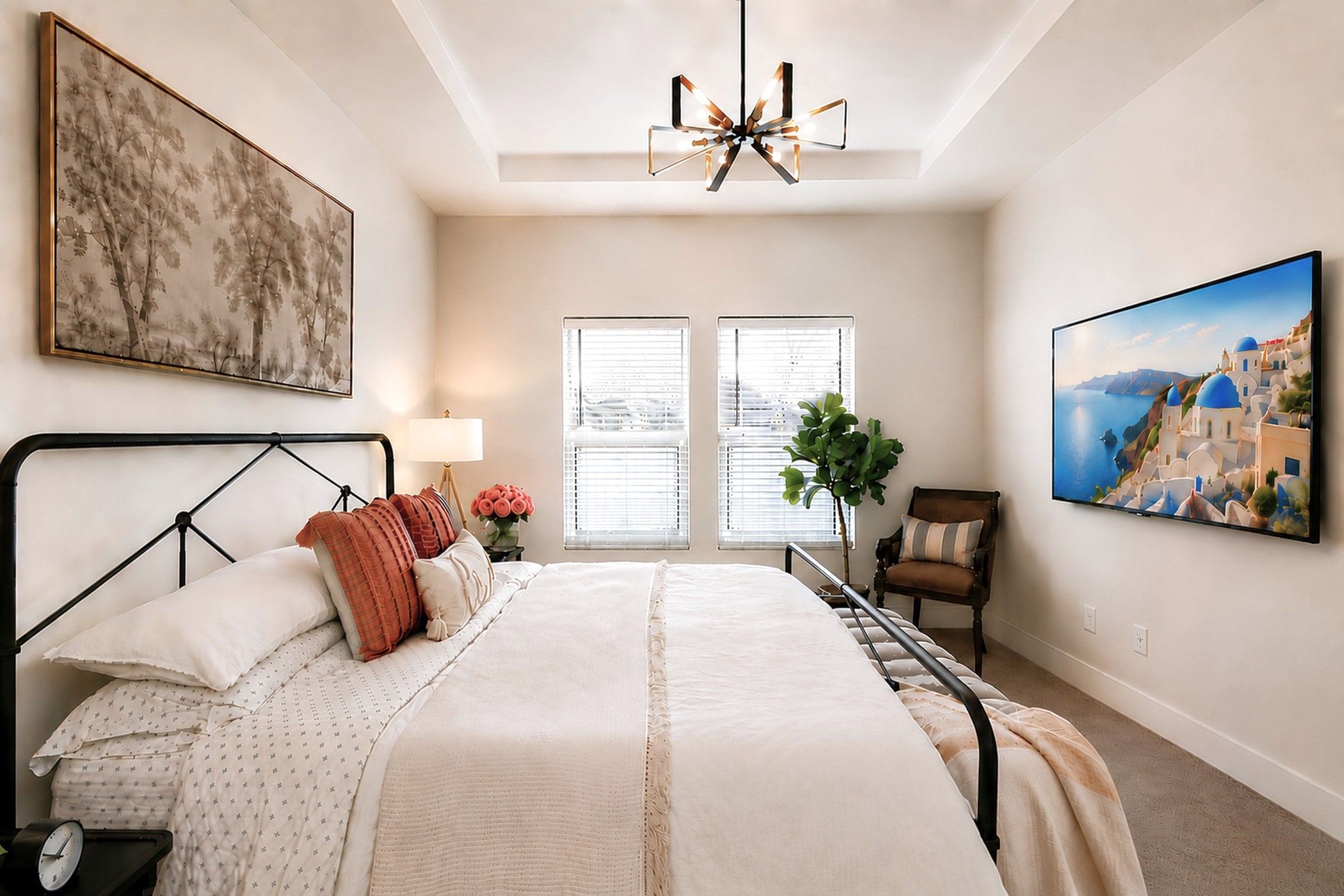 A bedroom with a bed, a bedside table with a lamp, a chair, and a large window.