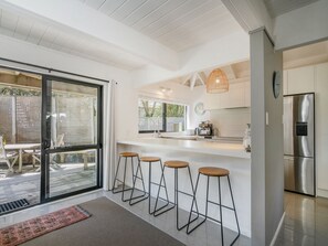Enjoy cooking in this well-equipped kitchen with a refrigerator, oven, and spacious island with bar stools.