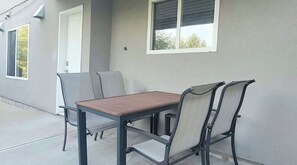 Enjoy dining or socializing in this outdoor seating area with a table and four chairs.