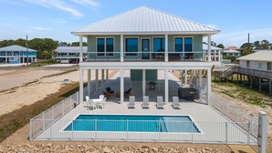 A two-story house with a pool, a covered patio, and a deck. - One Too Many: 5BR Home on SGI- Beach Views, Priv. Pool, Sleeps 14 (St. George Island)