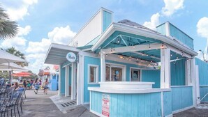 A small, blue and white building with a sign that reads "Melt."