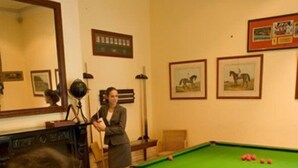 A pool table in a room with framed pictures on the wall and a fireplace. - New Charsfield Residential Apartments (Melbourne)