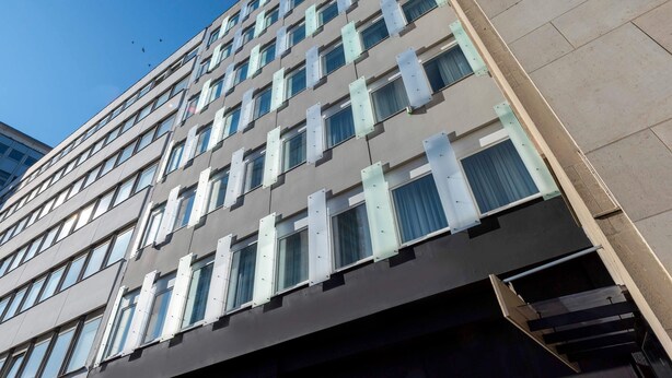 A multi-story building with a modern architectural design, featuring a series of windows and a visible entrance. - Greet Berlin Alexanderplatz (Berlin)