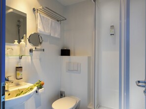 A modern bathroom with a sink, toilet, and shower. - Greet Berlin Alexanderplatz (Berlin)