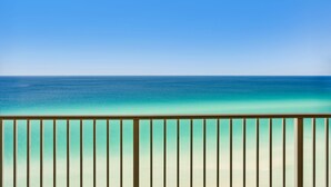 A clear view of a beach with a wooden railing in the foreground. - Waterfront condo w/ resort pool & daily tickets (Panama City Beach)