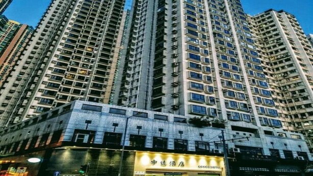 A high-rise building with multiple floors, featuring a commercial ground level with a hotel named 'COSMOSHOTEL'. - Hong Kong Cosco Hotel (Hong Kong)