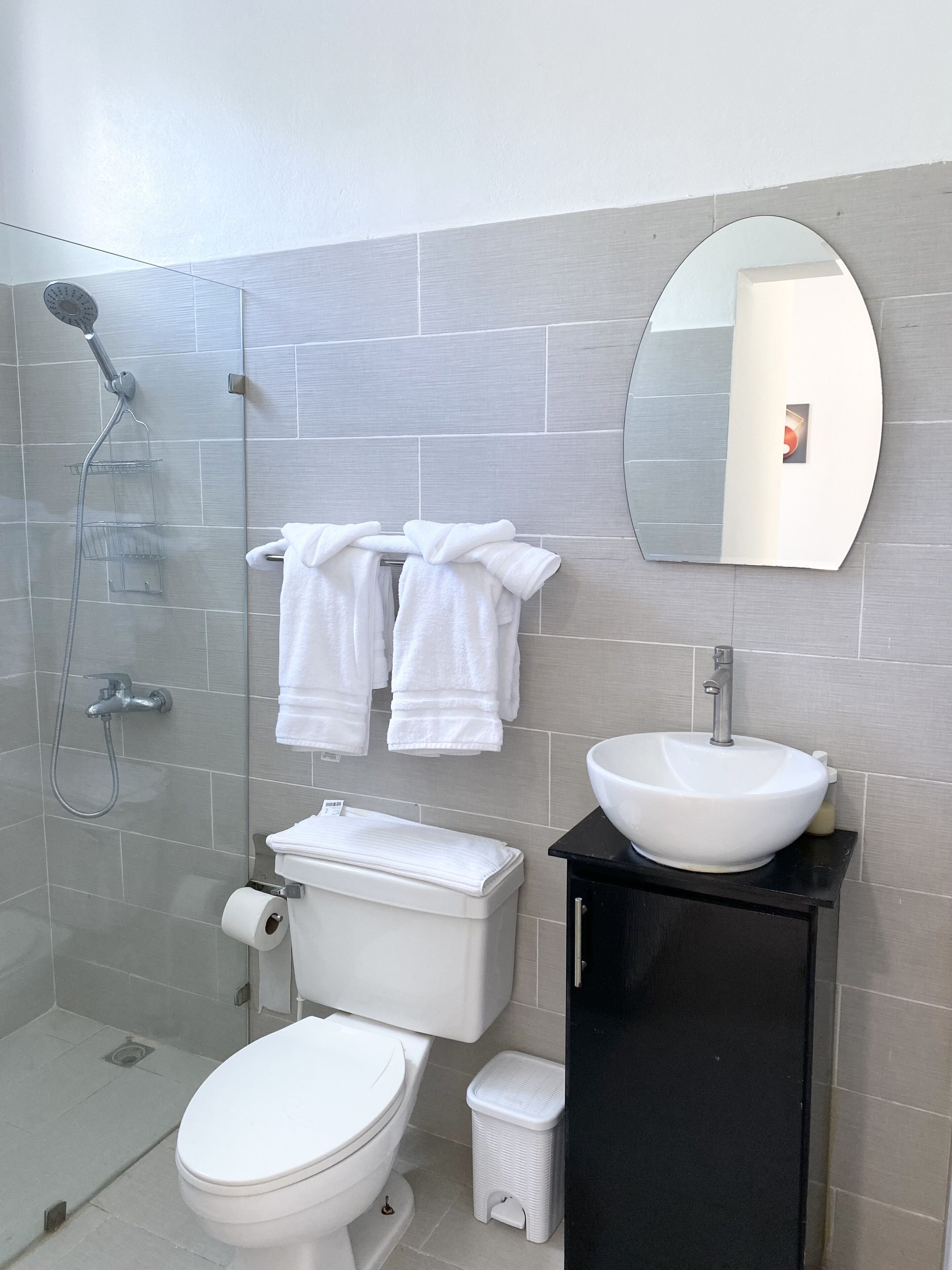 A modern bathroom with a toilet, bidet, and a sink.