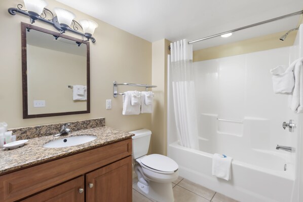 A bathroom with a sink, mirror, toilet, and bathtub. - 3BR- 11th floor- Lake & Golf View condo|Short walk to beach| Resort Access| (North Myrtle Beach)