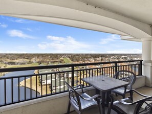 Enjoy a peaceful view of the surrounding residential area, golf course, and water from this balcony.