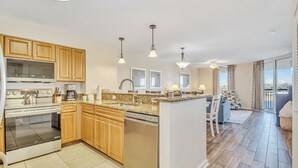 A modern kitchen with wooden cabinets, stainless steel appliances, and a central island. - 3BR- 7th floor- Lake & Golf View condo|Short walk to beach| Resort Access| (North Myrtle Beach)