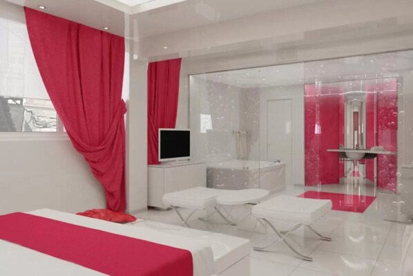 A modern room with a bed, a TV, and a glass partition.