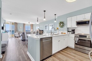 Enjoy cooking in this well-equipped kitchen with a central island, dishwasher, and stainless steel oven.
