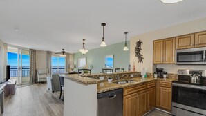 A modern kitchen with granite countertops, stainless steel appliances, and wooden cabinets. - Newly Refreshed & Cozy N. Myrtle Beach Condo with 15th Floor Ocean views (North Myrtle Beach)