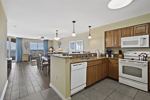 Enjoy cooking in this well-equipped kitchen with a central island, appliances, and ample natural light.