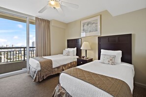 Enjoy a city view from the comfort of this room, featuring two beds with headboards and bedside tables.