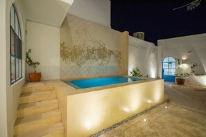 A modern outdoor pool area with a clear blue pool, a set of stairs leading up to the pool, and a potted plant near the stairs. - Luxury mediterranean Villa, perfect location (Mérida)