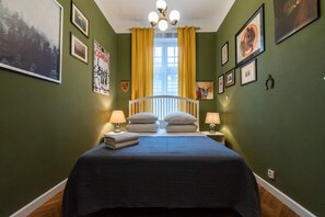 Cozy retreat with a large bed, bedside tables, and artwork adorns the walls.