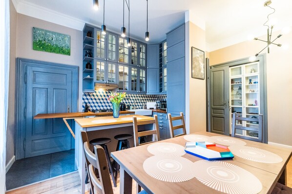 Enjoy cooking and dining in this well-equipped kitchen with a central island and ample counter space, perfect for meal preparation and seating for four.