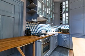 Fully equipped kitchen with a stove, oven, microwave, and coffee maker.