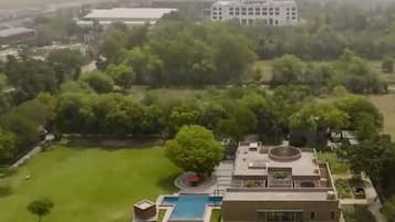 Surrounded by lush greenery, this two-story building offers a serene environment with a well-maintained lawn and pool.